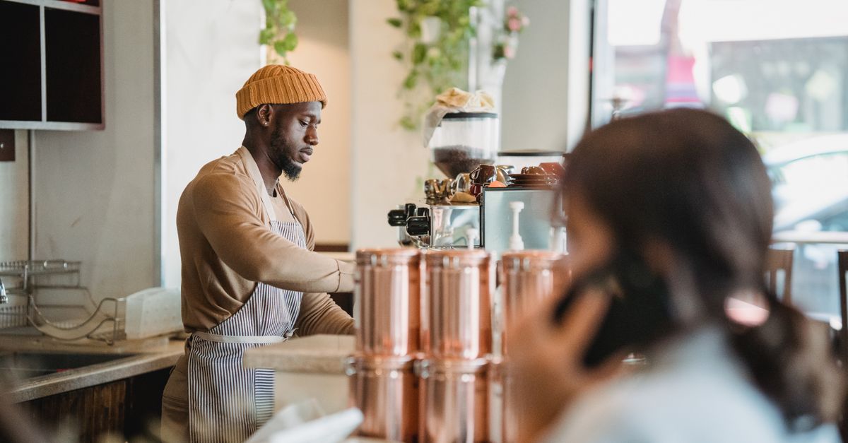 A barista preparing coffee at an independent coffee shop counter