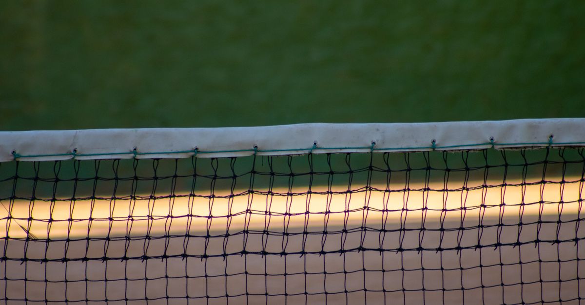 Close-up of a tennis net in evening light